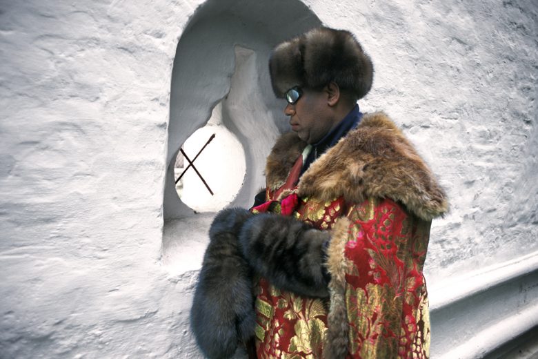 Andre Leon Talley, Vogue magazine's editor at large on his visit to Russia. This picture was taken inside the walls of The New Jerusalem Monastery, also known as the Voskresensky Monastery, Moscow Region. Andre Leon Talley's outfit consists of mink mittens and fur hat by Chado Ralp Rucci and antique Russian overcoat provided by Bolshoi Theatre.