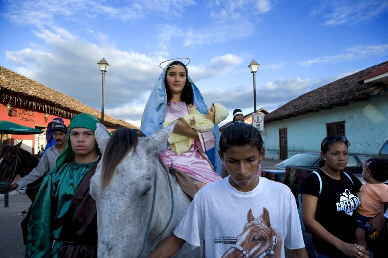 Virgin Mary and baby Jesus are being paraded on a donkey (or a horse?) through the streets of Granada, Nicaragua few days before Christmas.